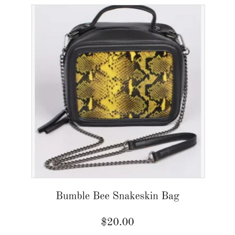 Black snakeskin bag with yellow designs on front.